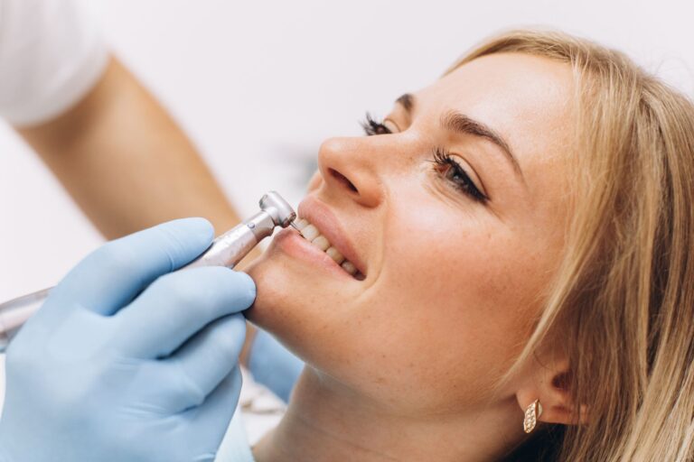 a dentist treats a woman s teeth in dental clinic