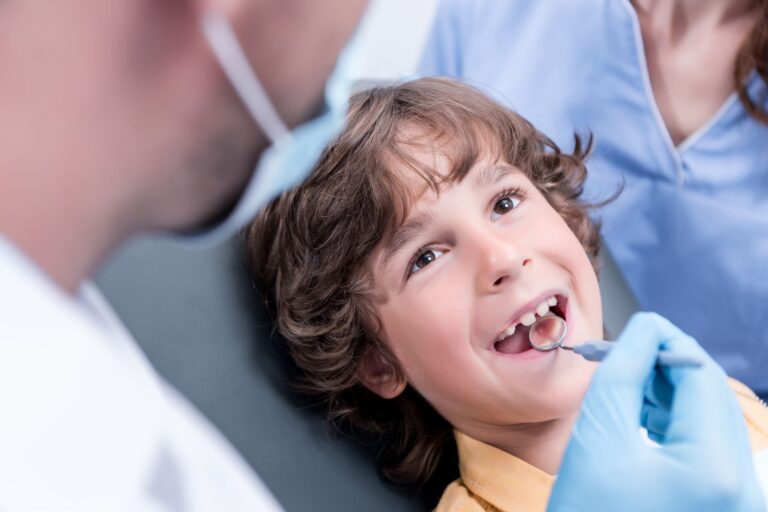 dentist examining teeth of little boy